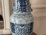 a large blue and white vase sitting on a table