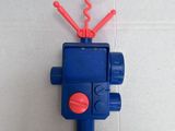 a blue and red toy gun on a white surface