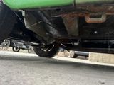 a green truck that is parked on the side of the road