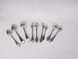 a lot of silver spoons and forks on the table