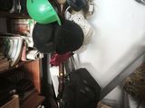 many hats hanging on a rack in a room