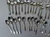 a lot of silver spoons and spoon spoons on the table