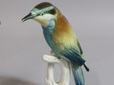three figurines of birds sitting on top of each other