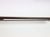 an old rifle with a wooden barrel and a wooden handle