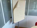 a white board with a sheet of paper on it in a room