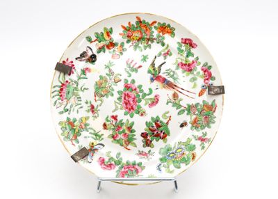 a plate with a bird and flowers design on it