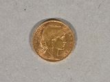 an image of a gold coin sitting on top of a white surface
