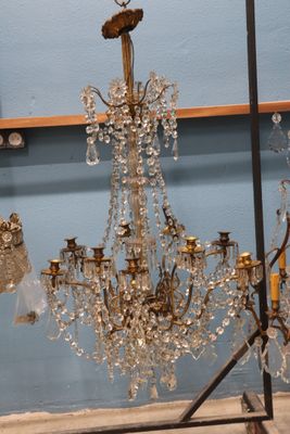 a chandelier with a bird on top of it in a room