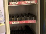 a refrigerator that has a lot of sodas in it