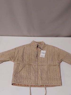 the children ' s jacket is tan and has a white tag on it