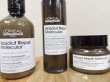 two bottles of hair products sitting on a table