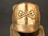 a gold helmet with two crossed bones on it