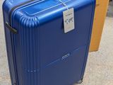 a blue suitcase sitting on the ground next to a cardboard box