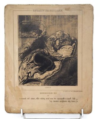 un vieux livre sur lequel figure le dessin d'un homme et d'une femme endormis sur un lit
