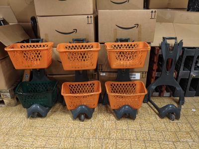 several orange baskets are stacked on top of each other in front of boxes