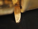 a knife that is sitting on a table next to a glass