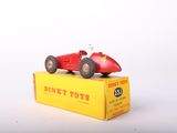 a red toy car sitting on top of a yellow box