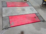 a red and white stripe on the ground next to a yellow truck