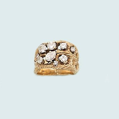 an image of a gold and diamond ring on a blue background
