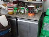 a small kitchen with a lot of clutter on the counter