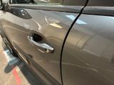 a close up of a car door handle with a sticker on it