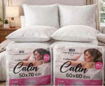 two pillows on top of a bed in a bedroom next to each other