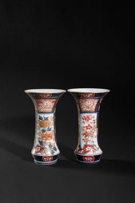 pair of chinese vases on a black background with a black background