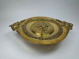 an image of a gold plate with a lion head on it