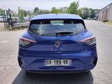 the rear end of a blue car parked on the side of a road