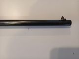 a close up of a black pipe on a white surface