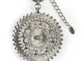 an image of a close up of a metal object on a chain
