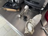 several kitchen appliances are sitting on a stainless steel counter top