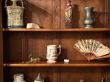 a wooden bookcase with a lot of different items on it