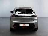 the rear end of a silver car in a white room