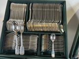 silverware in a green box with spoons and spoons in it