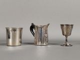 three silver cups sitting next to each other on a table