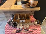 a table with a red and white checkered table cloth and a wooden box with utensils on it