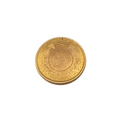a close up of a gold coin on a white background