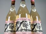 three bottles of white wine with a pink label on them