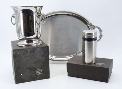 two silver vases and a silver plate on a table