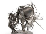 sculpture of a horse made of scrap metal on a base