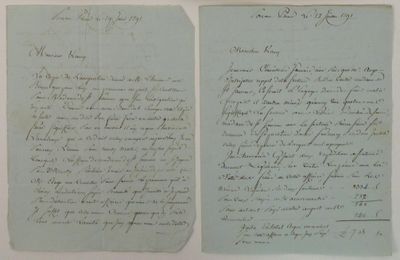 two old papers with handwriting on them sitting next to each other