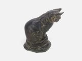 a statue of a cat that is sitting on a table