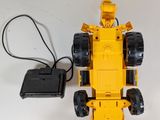 a yellow toy truck that is connected to a charger