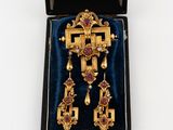 a close up of a box with a cross and a pair of earrings