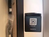 a small refrigerator with a qr code on the door