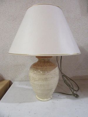 a lamp that is sitting on a table with a lamp shade on it