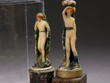 two figurines that are on display in a glass case