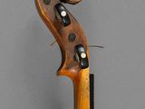 a close up of a violin neck with a wooden handle
