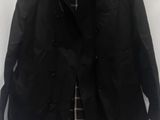 black trench coat with plaid shirt and tie on a hanger
